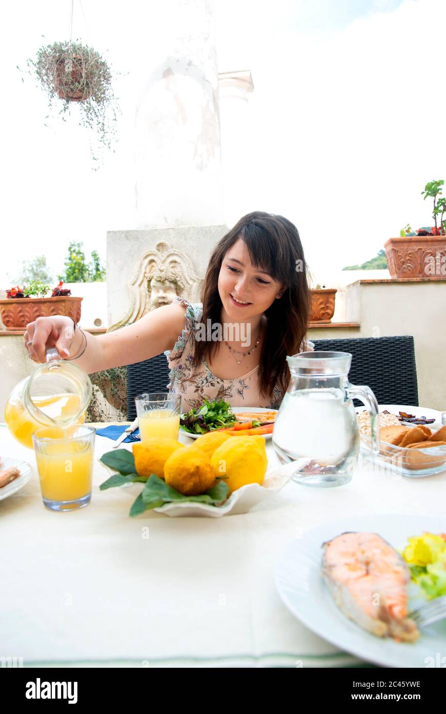 Young girl pouring orange juice hires stock photography and images Alamy
