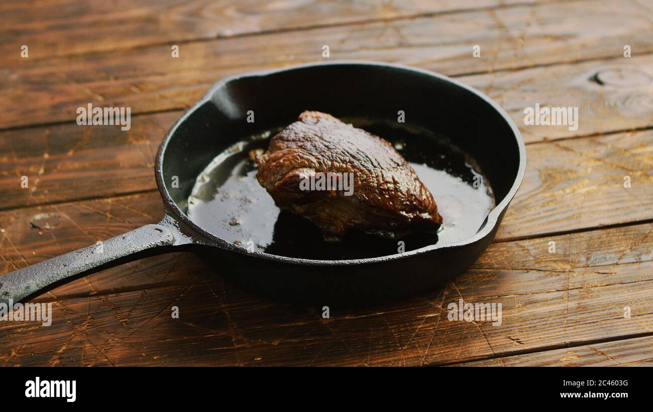 Meat and oil on skillet Stock Photo Alamy