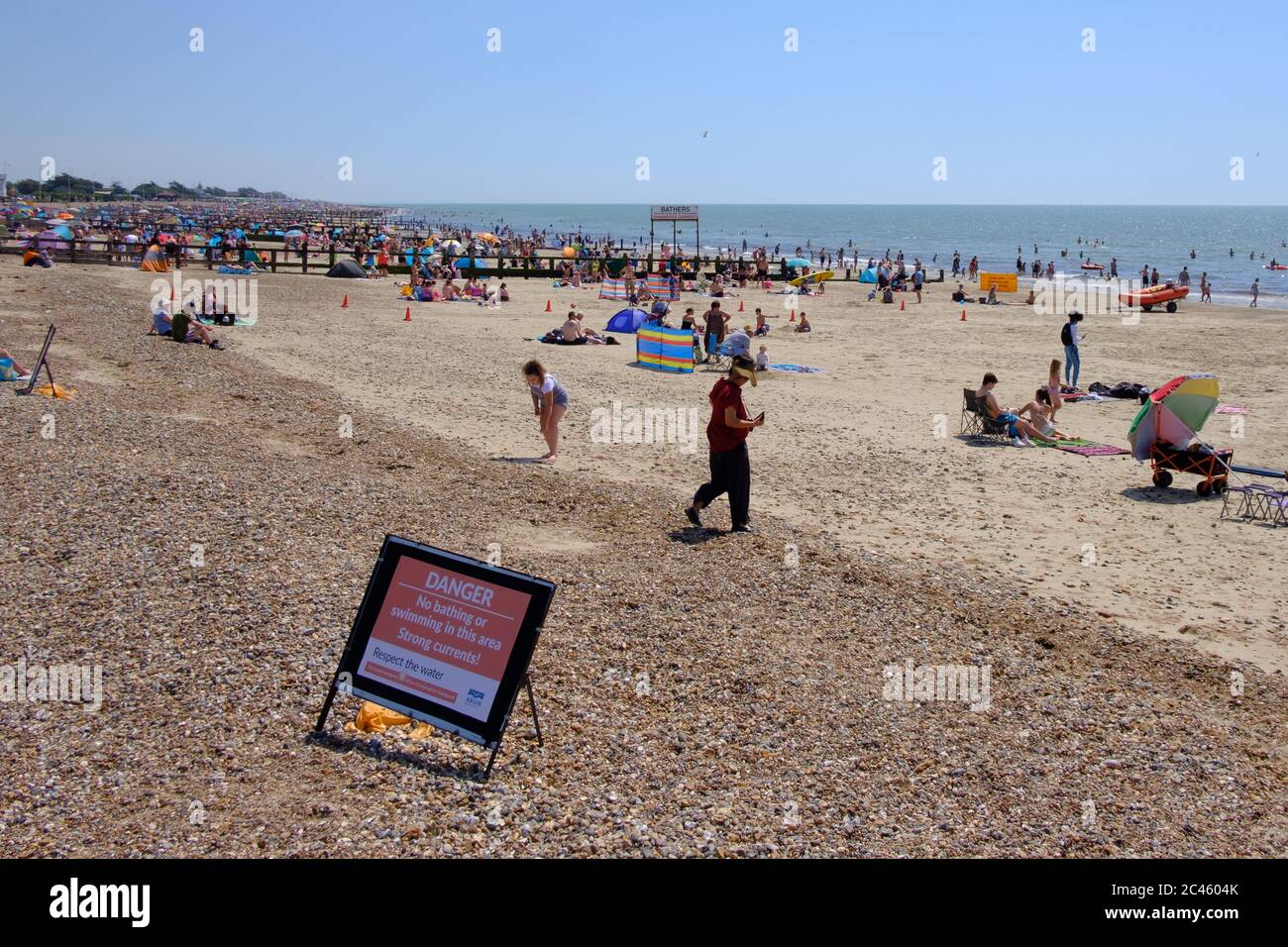 Littlehampton West Sussex. 24th June, 2020. UK Weather. People enjoying Littlehampton beach in a mini heatwave that saw temperatures soaring. People crammed in the best part of the beach leaving other parts of the beach empty and not adhering to social distancing and not taking heed of the warning not to swim due to dangerous currents Credit: Paul Chambers/Alamy Live News Stock Photo