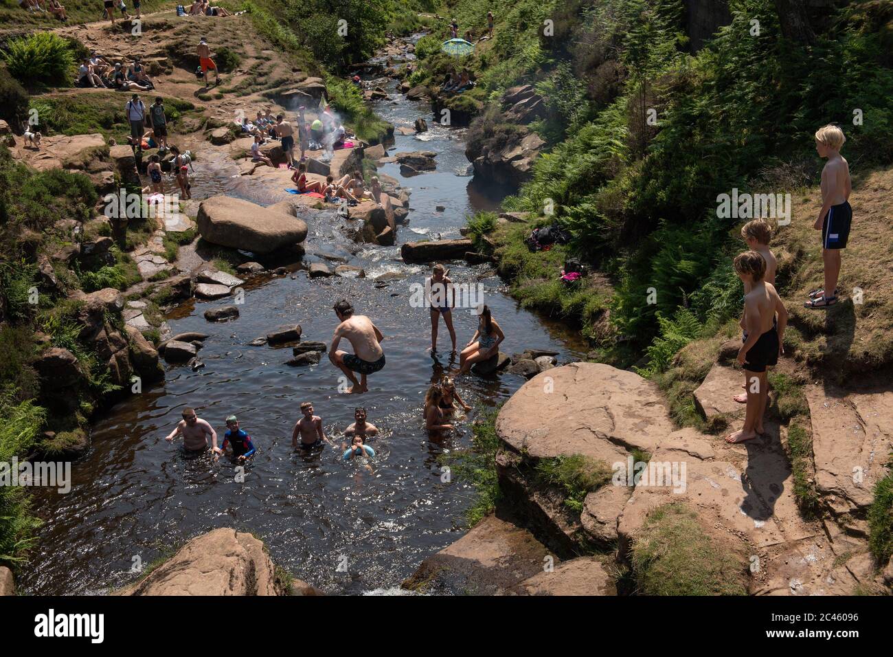 People enjoy the hot weather by Three Shires Head on the River Dane, where Cheshire, Derbyshire and Staffordshire meet, as Britain is braced for a June heatwave with temperatures set to climb into the mid-30s this week. Stock Photo