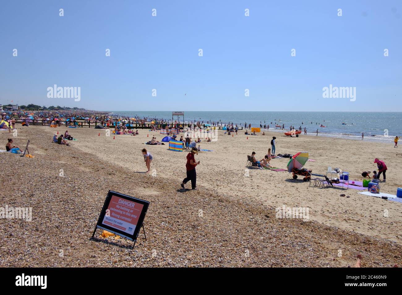 Littlehampton West Sussex. 24th June, 2020. UK Weather. People enjoying Littlehampton beach in a mini heatwave that saw temperatures soaring. People crammed in the best part of the beach leaving other parts of the beach empty and not adhering to social distancing and not taking heed of the warning not to swim due to dangerous currents Credit: Paul Chambers/Alamy Live News Stock Photo
