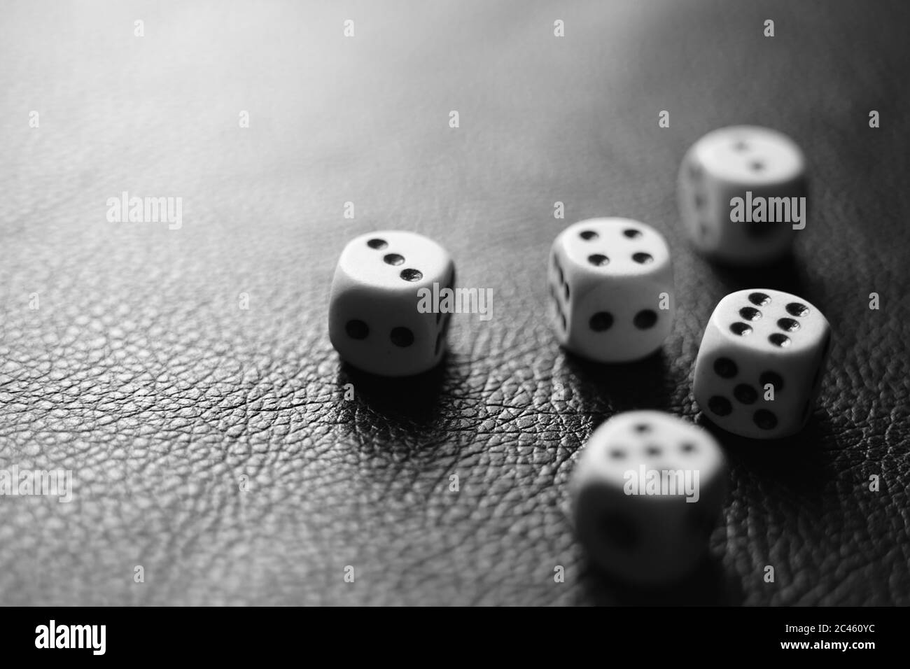 Several dice on the table. Black and white photo Stock Photo