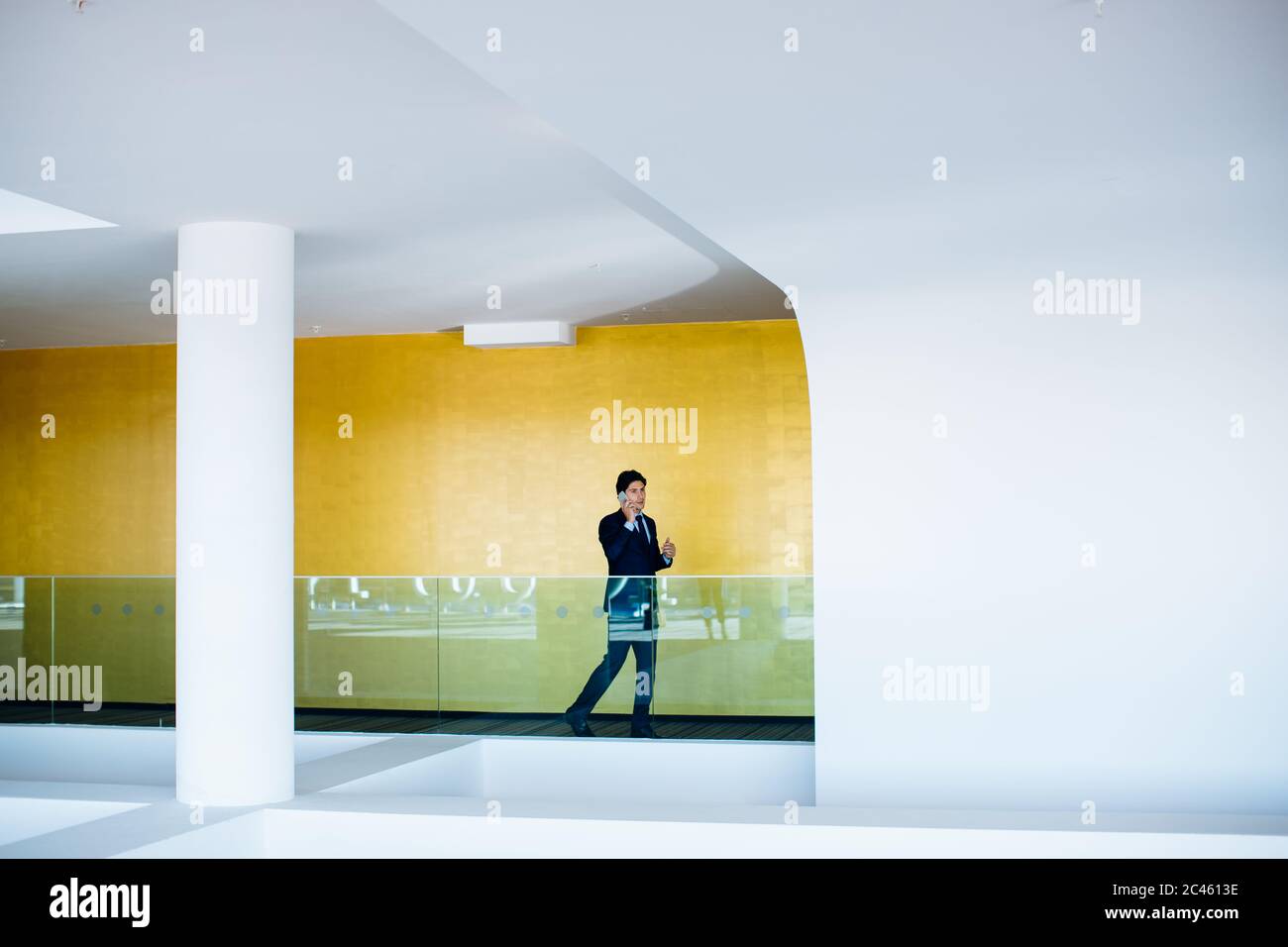 Businessman using mobile phone in hotel building Stock Photo