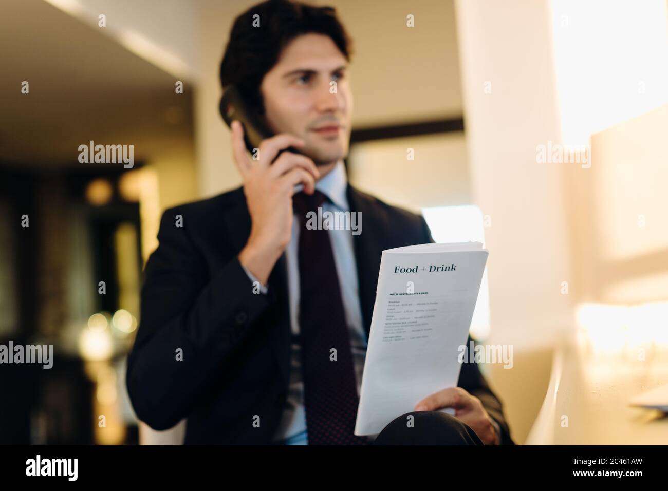 Businessman ordering room service in hotel Stock Photo