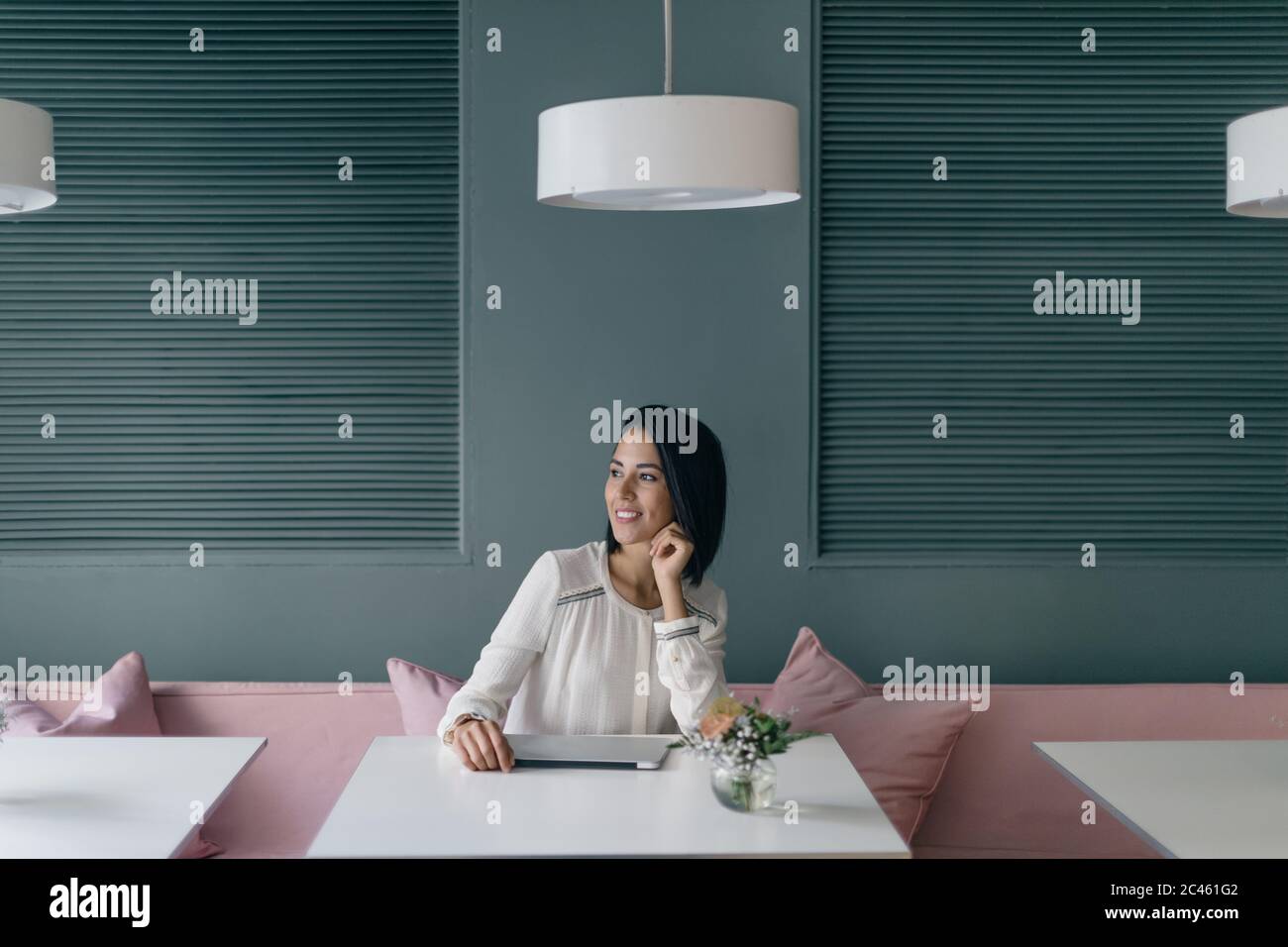 Young businesswoman at hotel table looking away Stock Photo