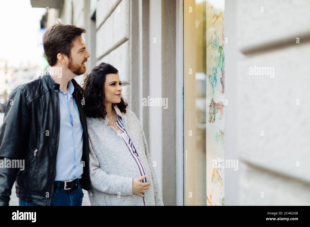 Pregnant couple window shopping, Florence, Italy Stock Photo