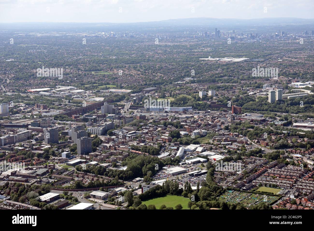 aerial view of Stockport town centre with Hempshaw Industrial Estate in the foreground and Manchester skyline in the distance Stock Photo