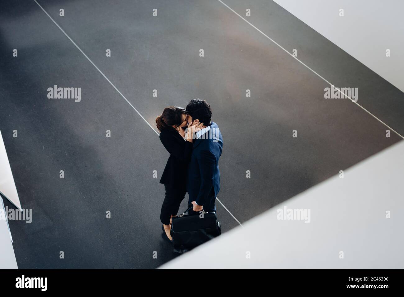 Couple in business suits kissing Stock Photo