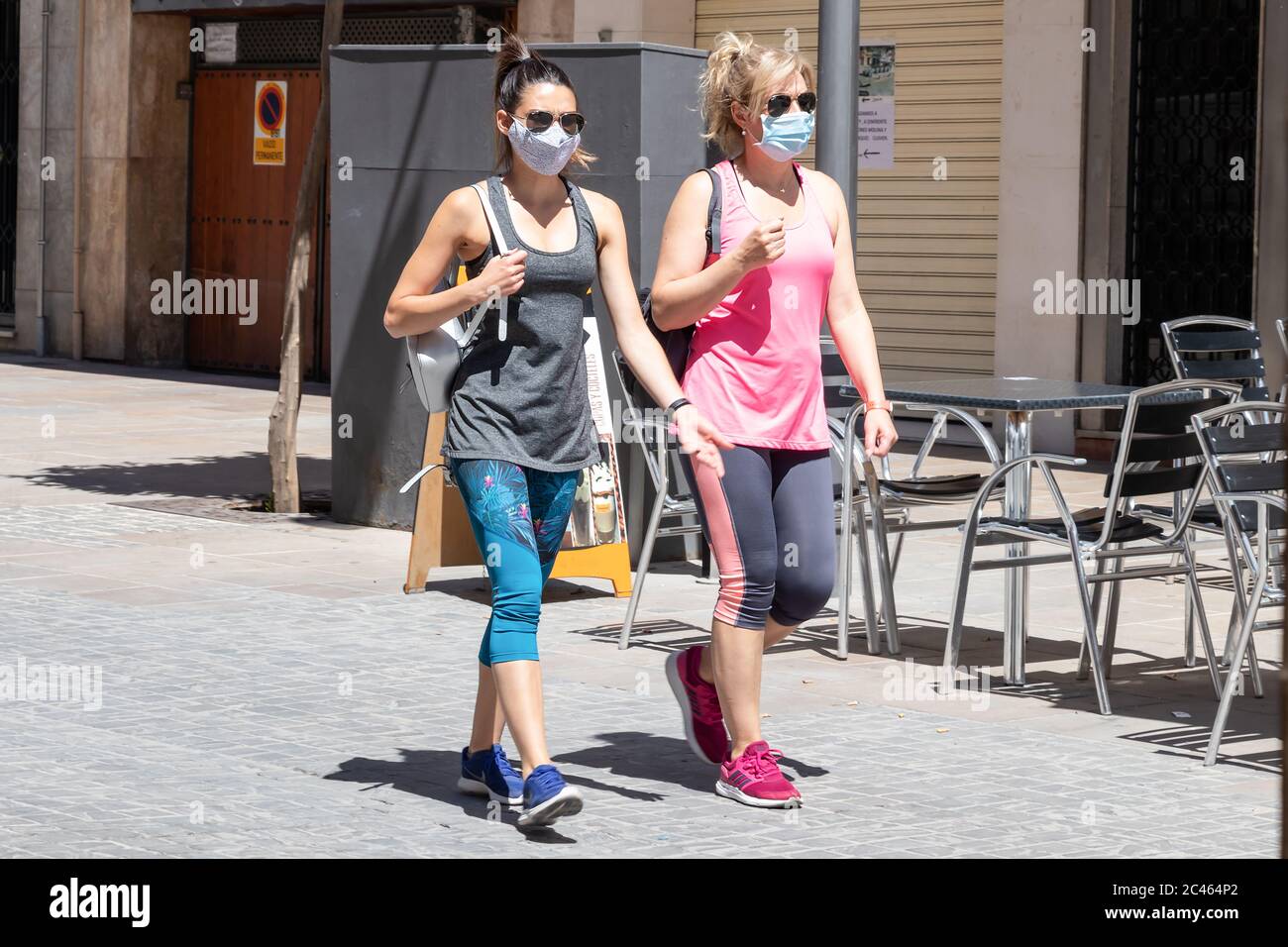 Ubeda, Jaen, Spain - June 19, 2020: Two women walking and wearing protective or medical face masks during the alarm state and quarantine in Spain. Stock Photo