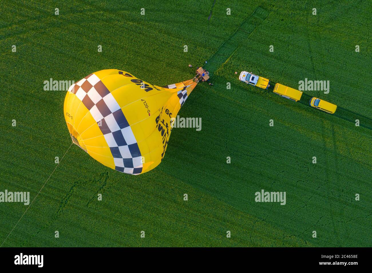 Cloppenburg, Germany. 23rd June, 2020. The band 'Crackerjacks' landed on a pasture with a hot-air balloon after they had held a balloon concert over the town of Cloppenburg (recorded with a drone). Credit: Mohssen Assanimoghaddam/dpa/Alamy Live News Stock Photo