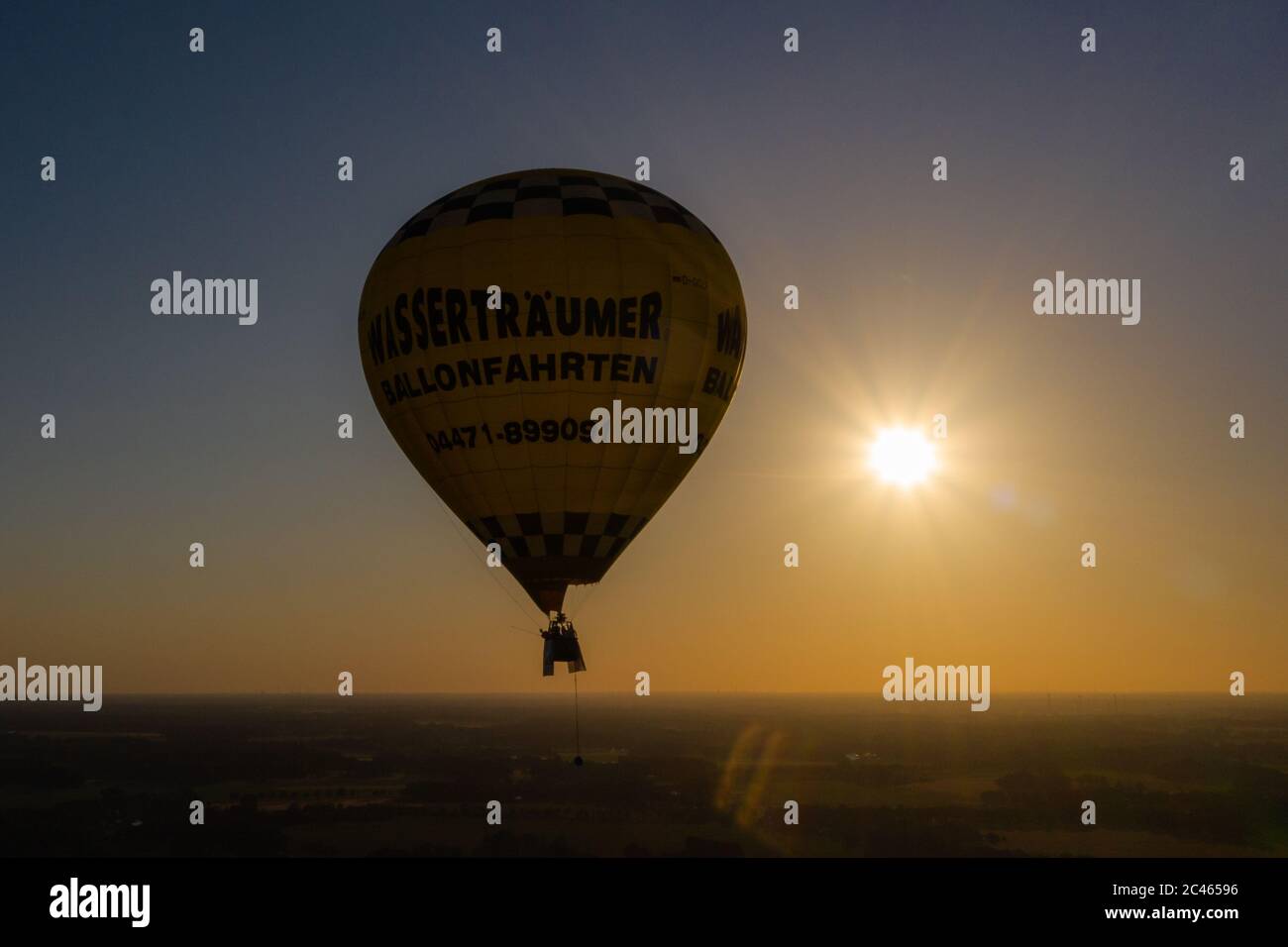 Cloppenburg, Germany. 23rd June, 2020. The band 'Crackerjacks' rides in a hot air balloon over Cloppenburg before the setting sun and gives a balloon concert (recorded with a drone). Credit: Mohssen Assanimoghaddam/dpa/Alamy Live News Stock Photo