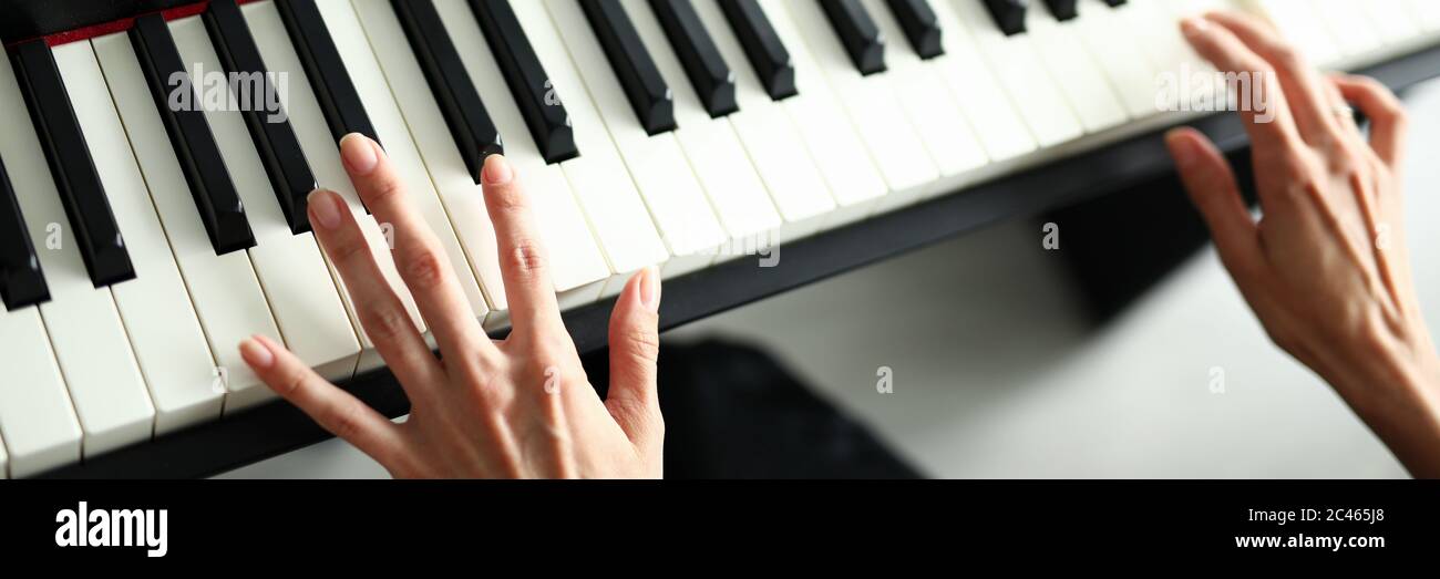 Beautiful female hands lie on a digital piano Stock Photo - Alamy