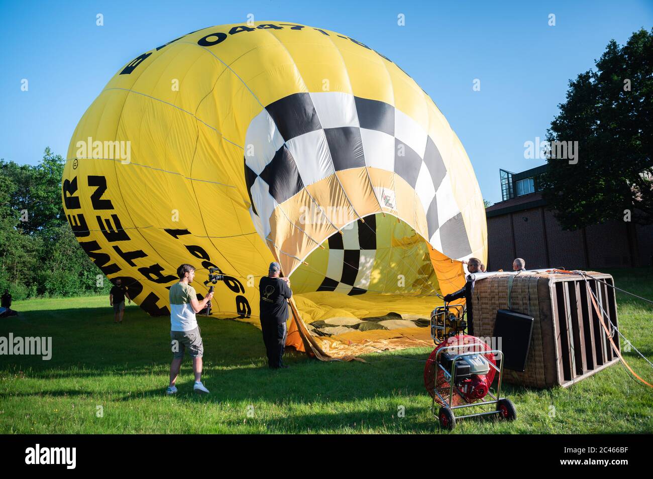 Cloppenburg, Germany. 23rd June, 2020. The hot-air balloon, from which the band 'Crackerjacks' has planned a balloon concert over the town of Cloppenburg, is being prepared for the trip on a meadow. Credit: Mohssen Assanimoghaddam/dpa/Alamy Live News Stock Photo