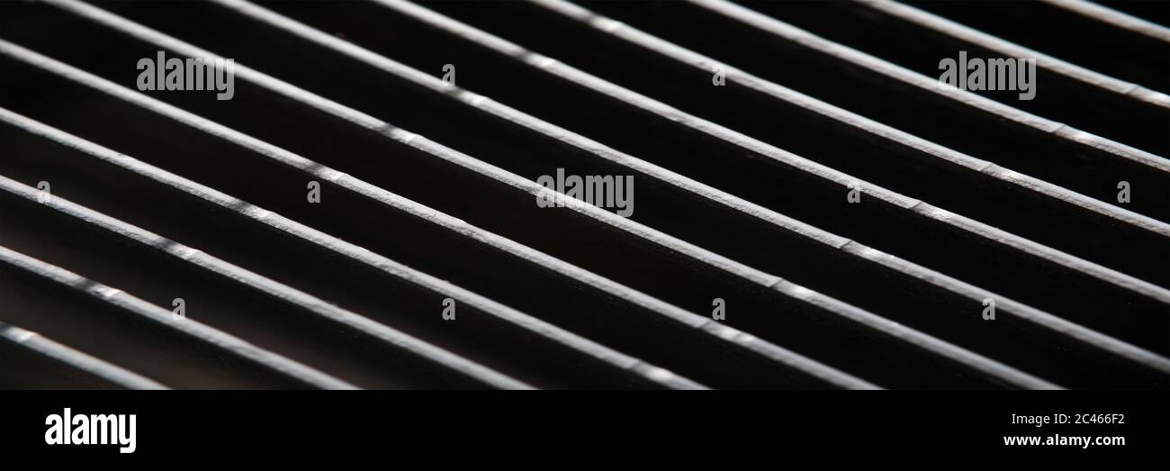 Dark gray metal grating in low light technique Stock Photo
