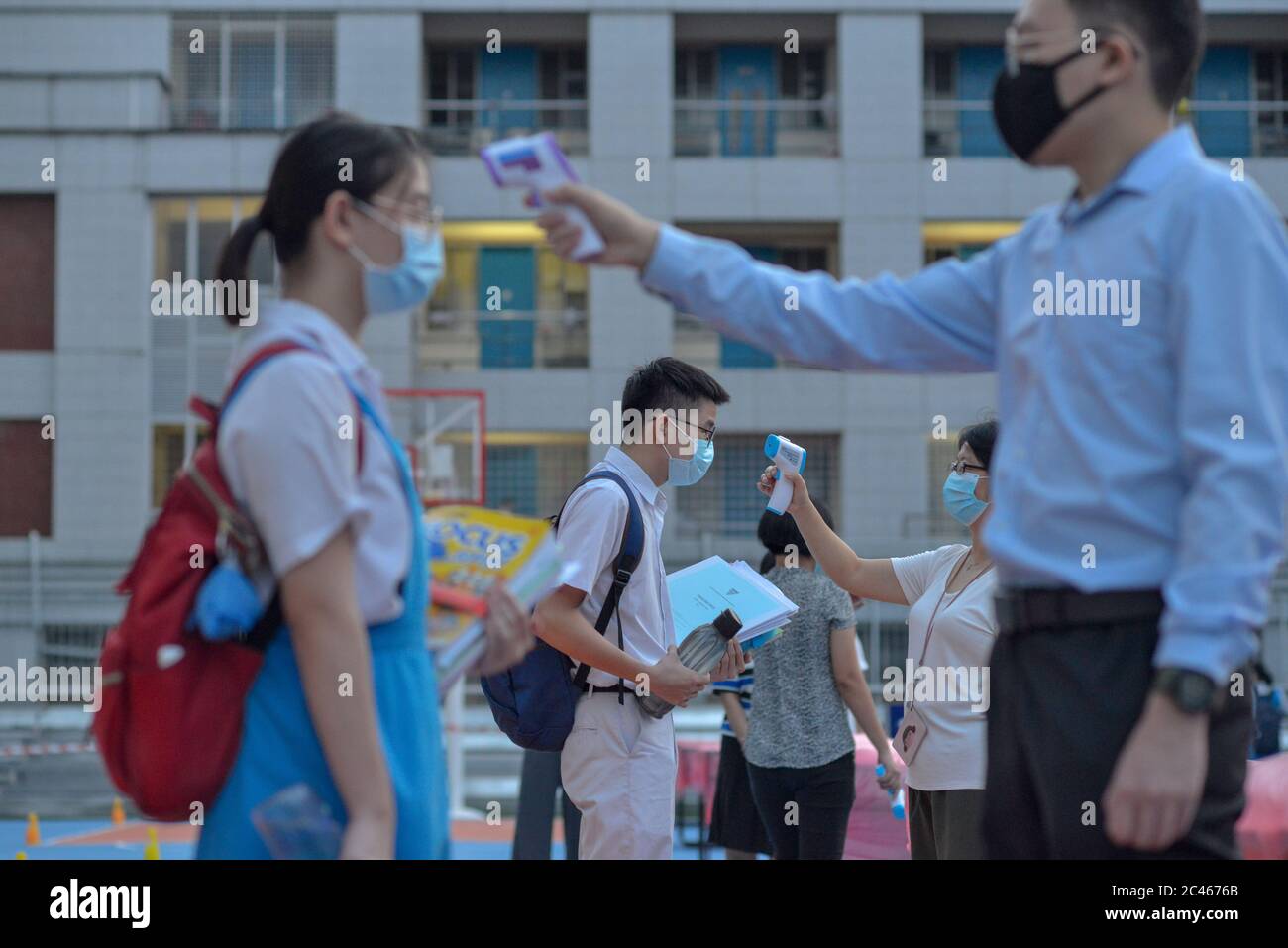 Kuala Lumpur, Malaysia. 24th June, 2020. Students have their body temperatures checked before entering classroom at a high school in Kuala Lumpur, Malaysia, June 24, 2020. The reopening of schools for middle schools senior grade students in Malaysia proceeded on Wednesday in compliance with new standard operating procedures (SOP), after a nearly three month closure due to the outbreak of COVID-19. Credit: Chong Voon Chung/Xinhua/Alamy Live News Stock Photo