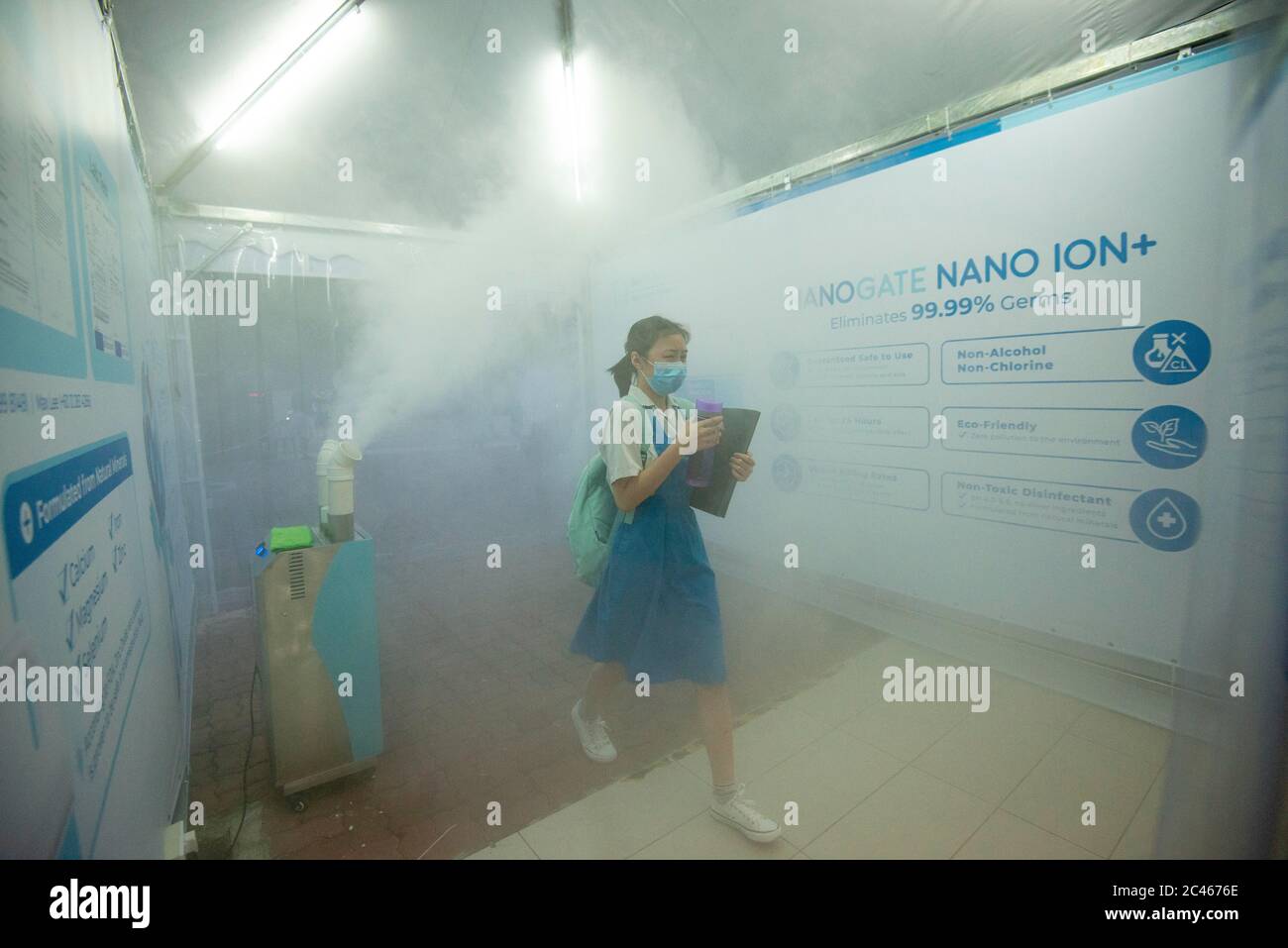 Kuala Lumpur, Malaysia. 24th June, 2020. A student walks through a disinfection gate before entering classroom at a high school in Kuala Lumpur, Malaysia, June 24, 2020. The reopening of schools for middle schools senior grade students in Malaysia proceeded on Wednesday in compliance with new standard operating procedures (SOP), after a nearly three month closure due to the outbreak of COVID-19. Credit: Chong Voon Chung/Xinhua/Alamy Live News Stock Photo