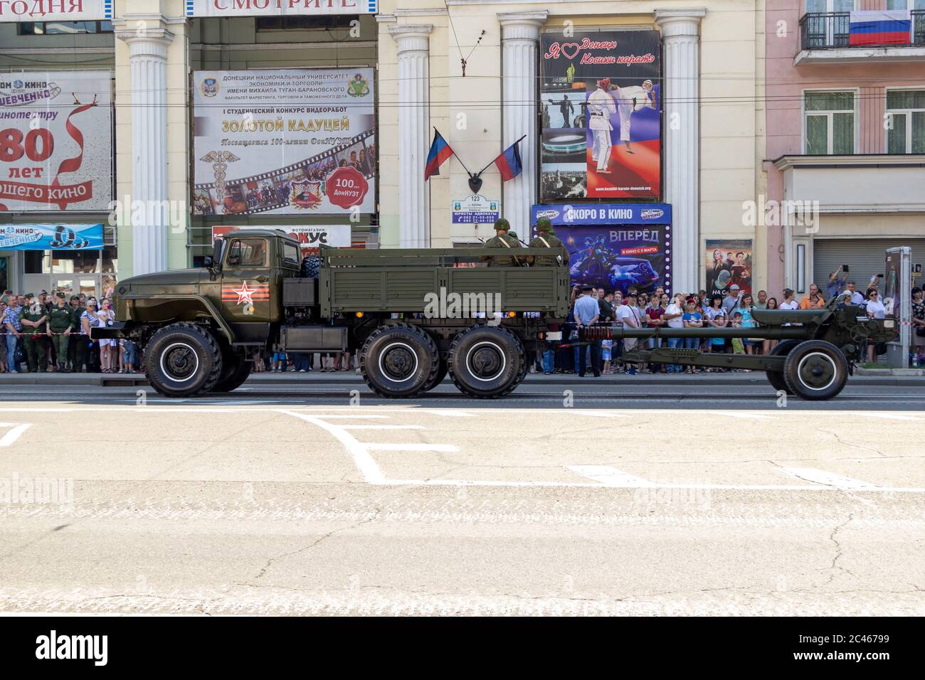 Donetsk, Donetsk People Republic, Ukraine, June 24, 2020: A convoy of military vehicles with Soviet artillery guns on a trailer moves along Artyom Str Stock Photo