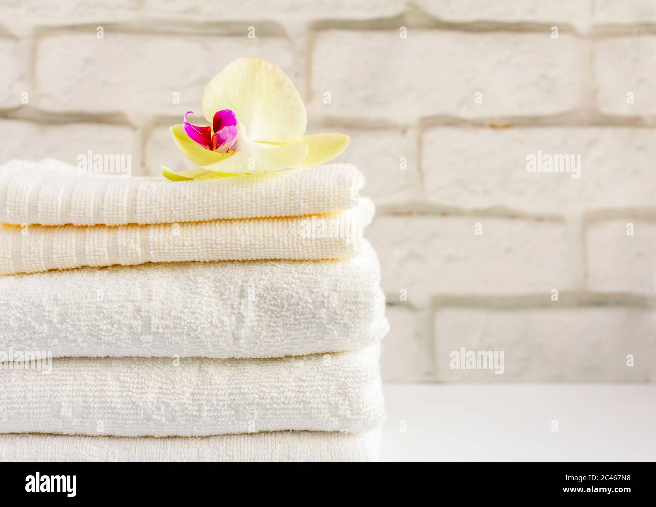A stack of clean white Terry towels on a light background Stock Photo