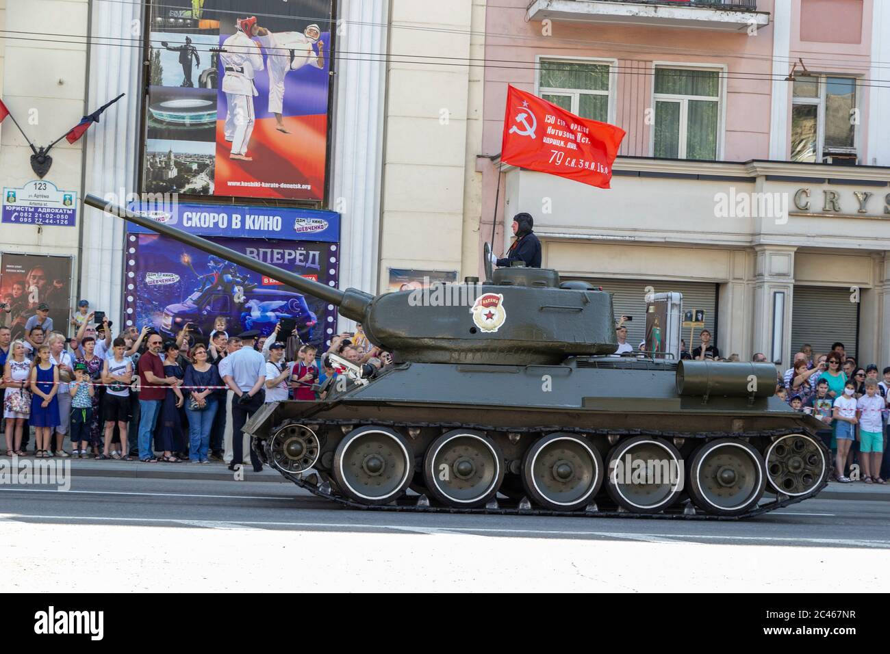 Donetsk, Donetsk People Republic, Ukraine - June 24, 2020: Soviet tank T-34 rides along the Artema street during the Victory Parade with the flag of t Stock Photo