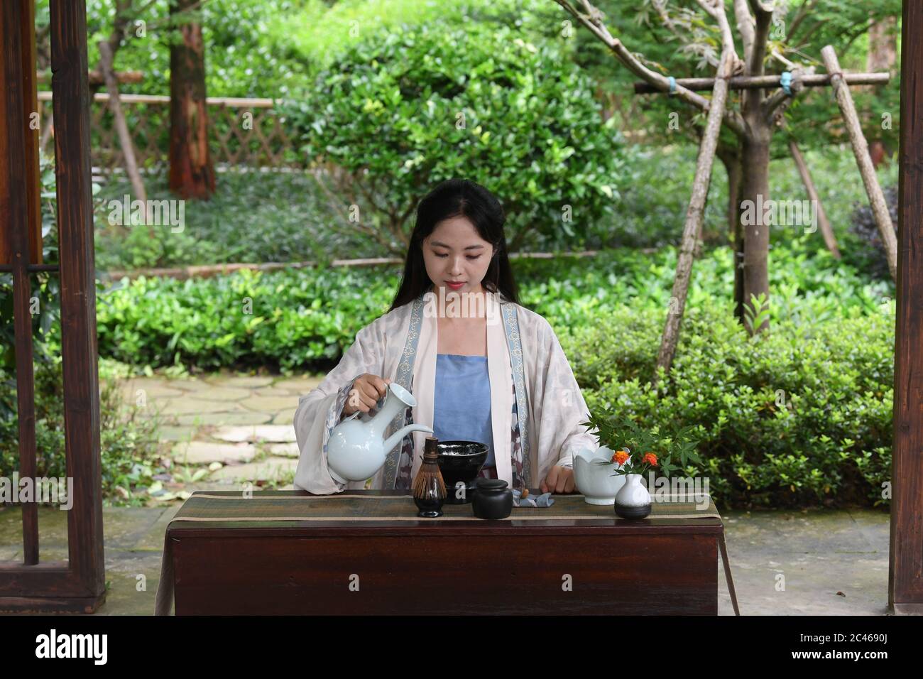 Hangzhou, East China's Zhejiang Province. 23rd June, 2020. Zhou Ying, a local tea master, demonstrates the Jingshan tea ceremony in Jingshan Town, Hangzhou, East China's Zhejiang Province, June 23, 2020. Located in northwest of Hangzhou, Jingshan Temple was once famous for its tea ceremony that was even exported to Japan during the period of 1127 to 1279. Today, the locals are working hard to restructure the temple, bringing out revival of the tea ceremony. Credit: Weng Xinyang/Xinhua/Alamy Live News Stock Photo