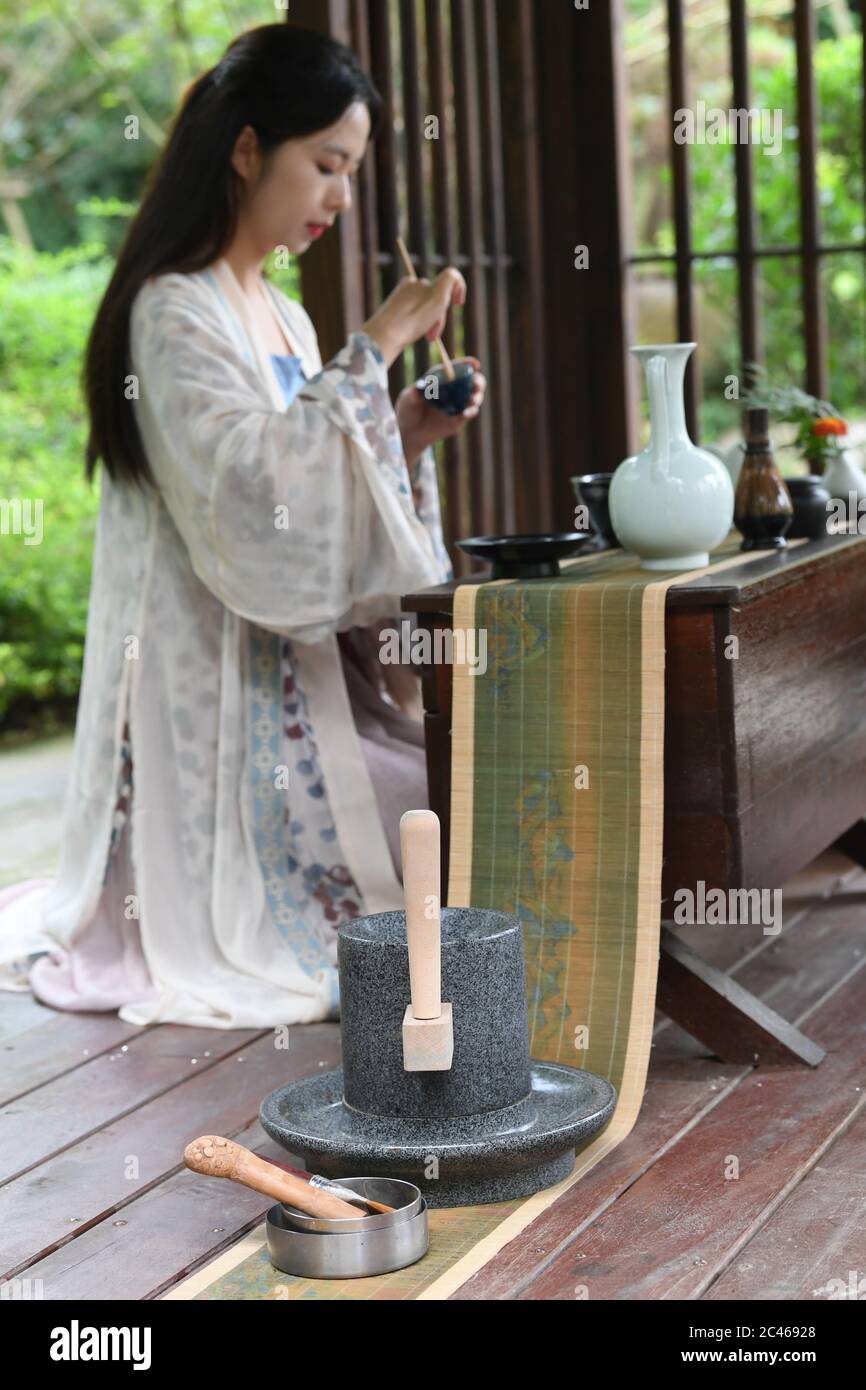 Hangzhou, China's Zhejiang Province. 23rd June, 2020. Zhou Ying, a local tea master, demonstrates the Jingshan tea ceremony in Jingshan Town, Hangzhou, east China's Zhejiang Province, June 23, 2020. Located in northwest of Hangzhou, Jingshan Temple was once famous for its tea ceremony that was even exported to Japan during the period of 1127 to 1279. Today, the locals are working hard to restructure the temple, bringing out revival of the tea ceremony. Credit: Weng Xinyang/Xinhua/Alamy Live News Stock Photo