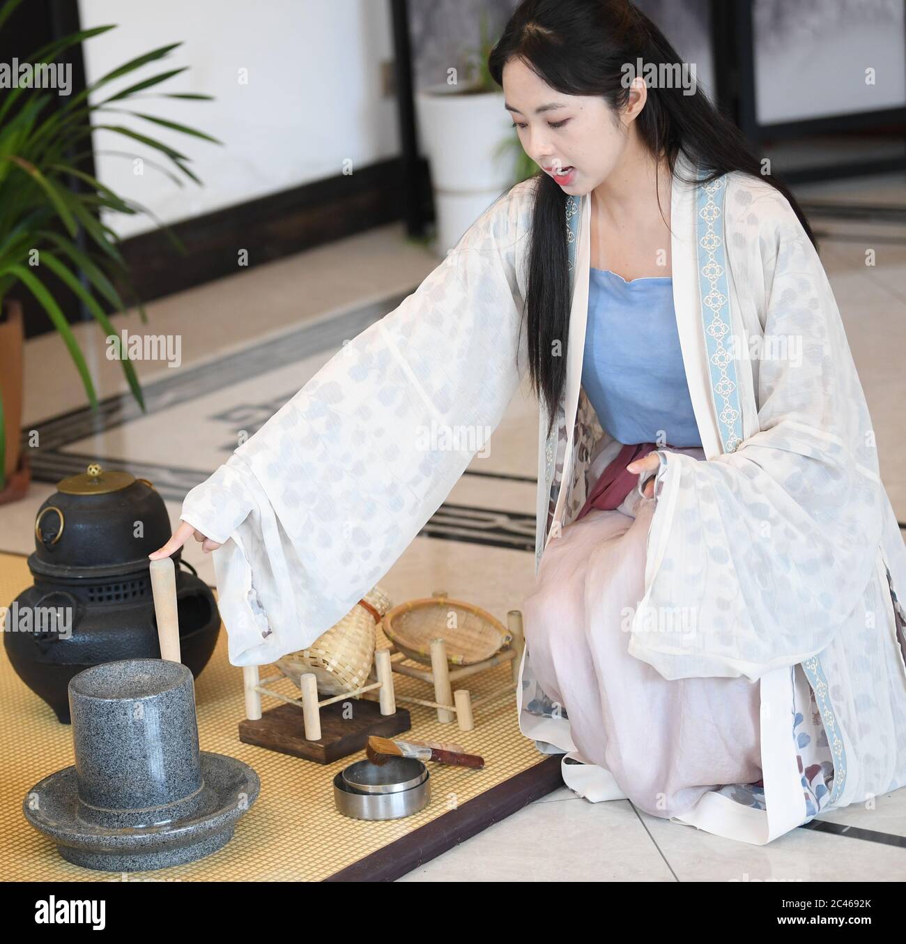 Hangzhou, East China's Zhejiang Province. 23rd June, 2020. Zhou Ying, a local tea master, demonstrates the Jingshan tea ceremony in Jingshan Town, Hangzhou, East China's Zhejiang Province, June 23, 2020. Located in northwest of Hangzhou, Jingshan Temple was once famous for its tea ceremony that was even exported to Japan during the period of 1127 to 1279. Today, the locals are working hard to restructure the temple, bringing out revival of the tea ceremony. Credit: Weng Xinyang/Xinhua/Alamy Live News Stock Photo
