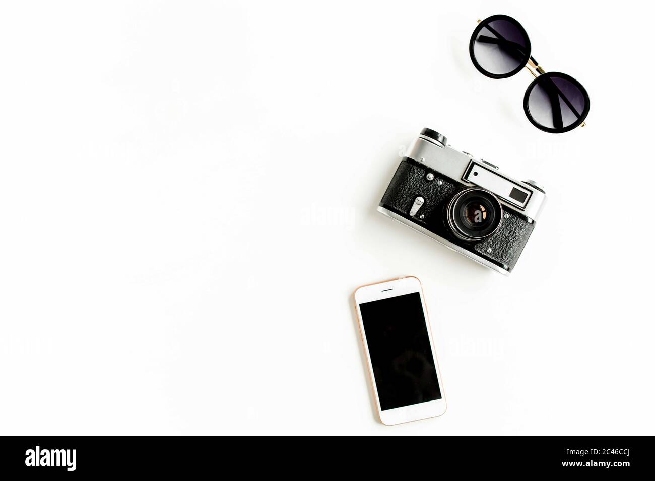 Traveler accessories concept on white background. Retro camera, telephone, sunglasses. Summer background. Flat lay Stock Photo