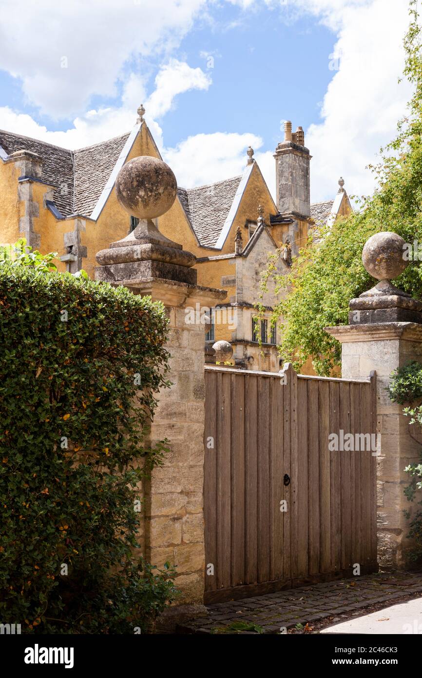 A glimpse of 16th century (1590) Ablington Manor in the Cotswold village of Ablington, Gloucestershire UK Stock Photo