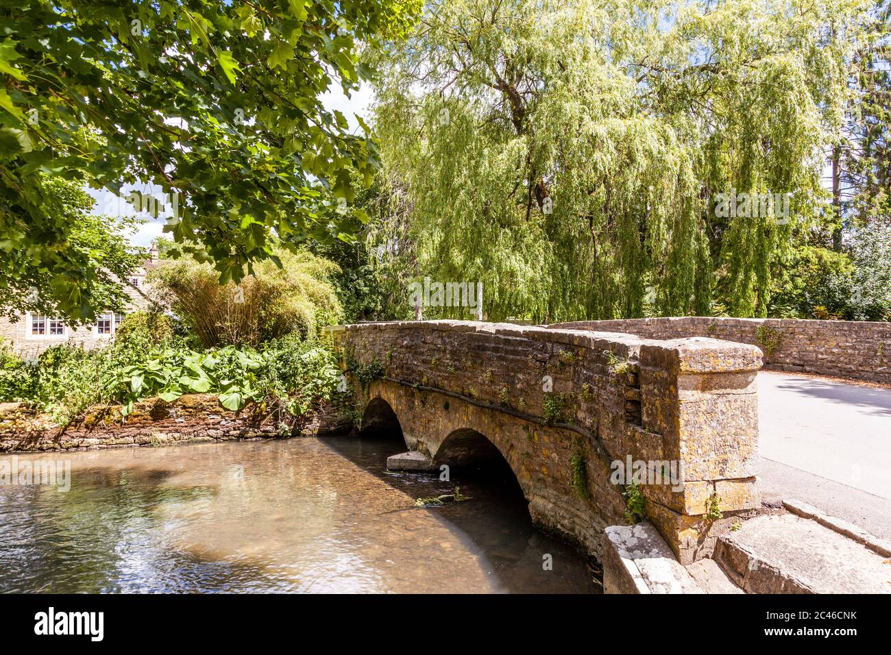 The River Coln flowing under the bridge in the Cotswold village of Ablington, Gloucestershire UK Stock Photo