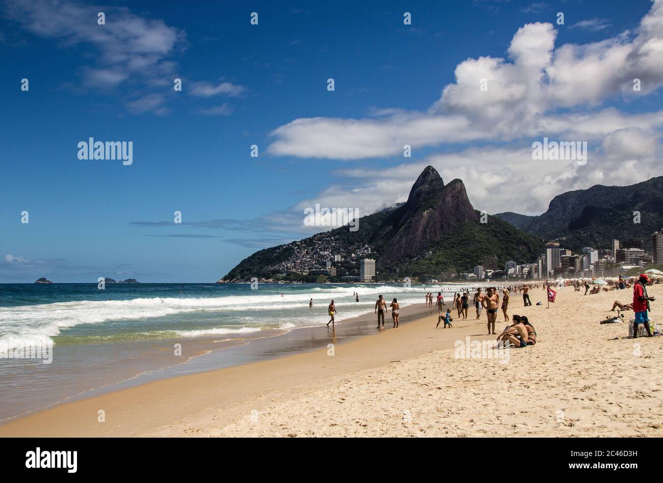 Rio de Janeiro, Brazil - Ipanema Beach with the wealthy skyline of Leblon, Vidigal slum (favela) and Dois Irmaos Hill in the background Stock Photo