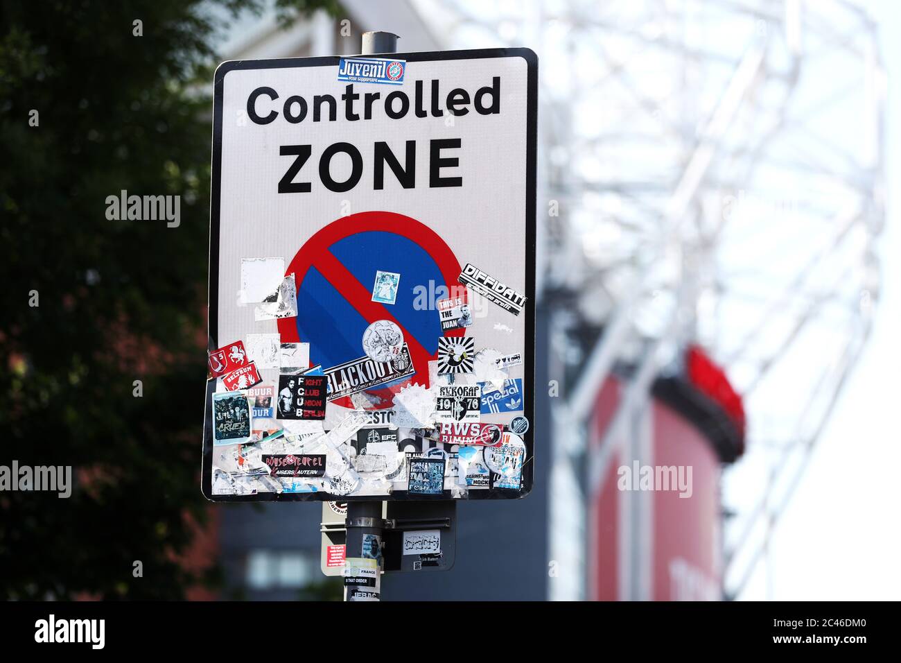 A general view of football stickers on a road sign outside Old Trafford in Manchester where Manchester United are playing Sheffield United in the Premier League this evening. Stock Photo