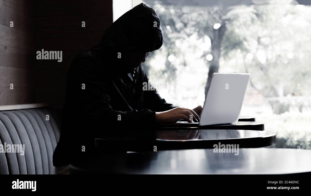 silhouette hacker typing laptop on cafe and distance from social with Banner size Stock Photo
