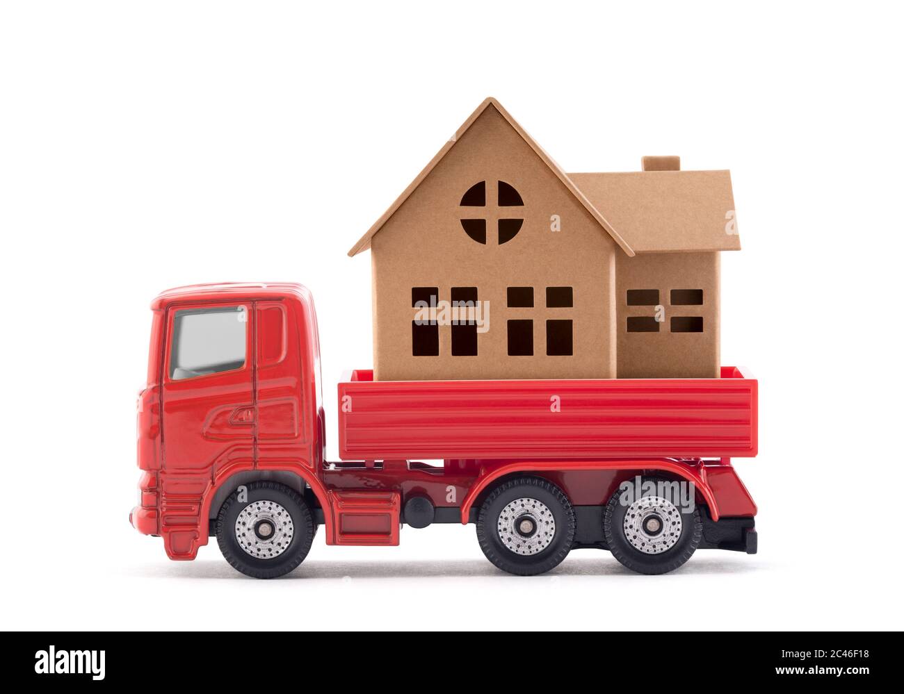 Red truck miniature with house on white background Stock Photo