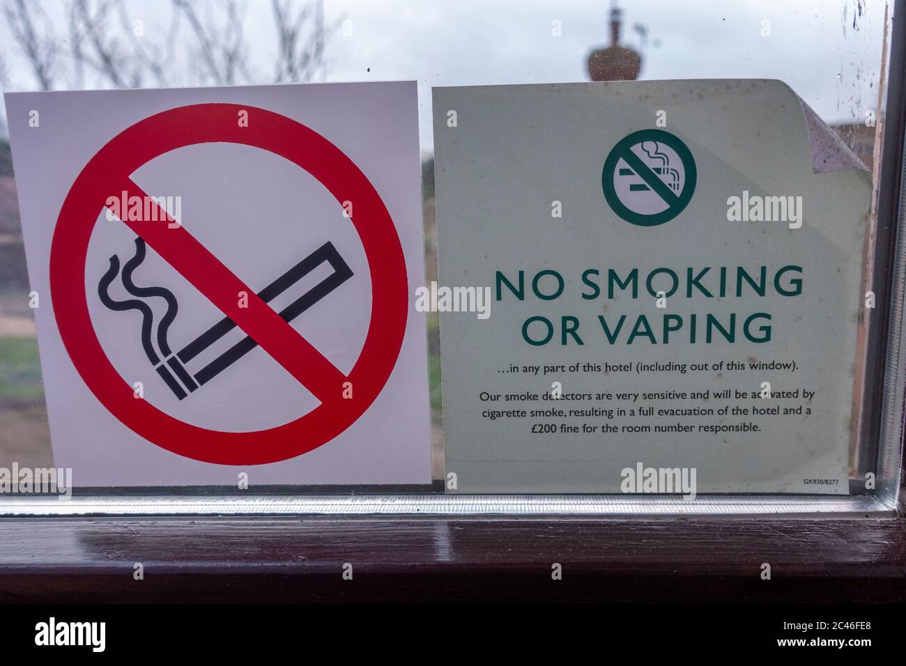'No Smoking' and 'No Smoking or Vaping' stickers on a hotel bedroom