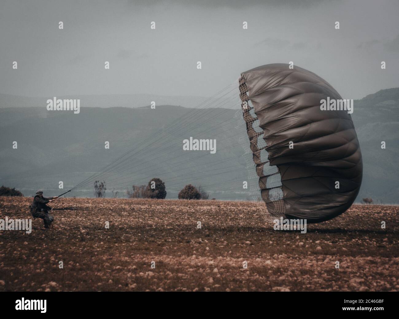 Amazing shot of an airborne forces soldier landing in a mission zone Stock Photo