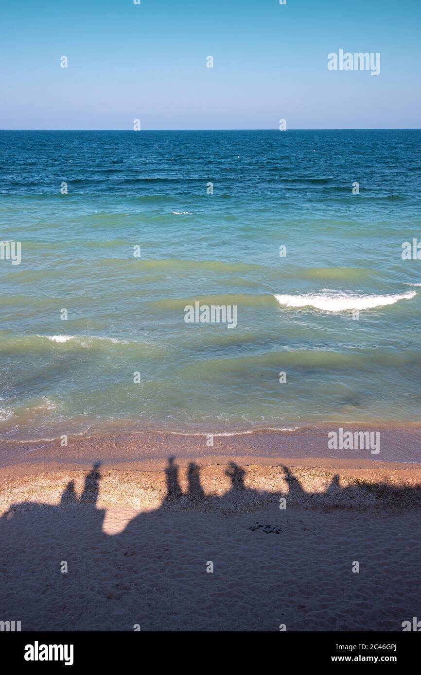 Silhouettes of people at the seaside Stock Photo