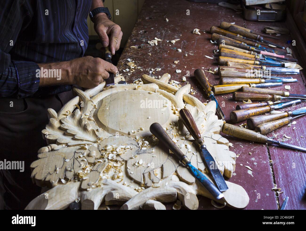 Senior man making a wood carving Stock Photo