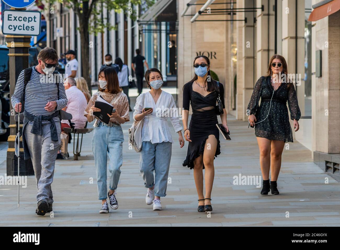 London, UK. 24th June, 2020. New bond Street is busier and many people wear masks despite it being the hottest day of the year, although not every shop is open, after all shops are now allowed to do so during the easing of the Coronavirus (covid 19) Lockdown. Credit: Guy Bell/Alamy Live News Stock Photo