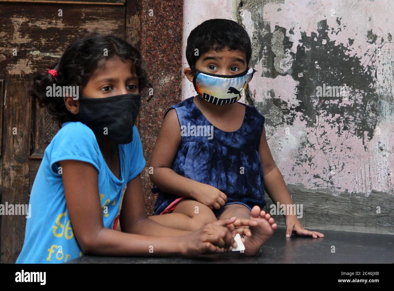 Children wearing protective masks are seen inside a slum colony.The Union Health Ministry on Sunday said the Maharashtra government and the Brihanmumbai Municipal Corporation (BMC) have been able to effectively bring down the covid-19 spread in Dharavi, Asia's largest slum colony. The BMC adopted a model of actively following four T’s – Tracing, Tracking, Testing and Treating. An effective containment strategy, conducting comprehensive testing and ensuring uninterrupted supply of goods and essential supplies to the community. Stock Photo
