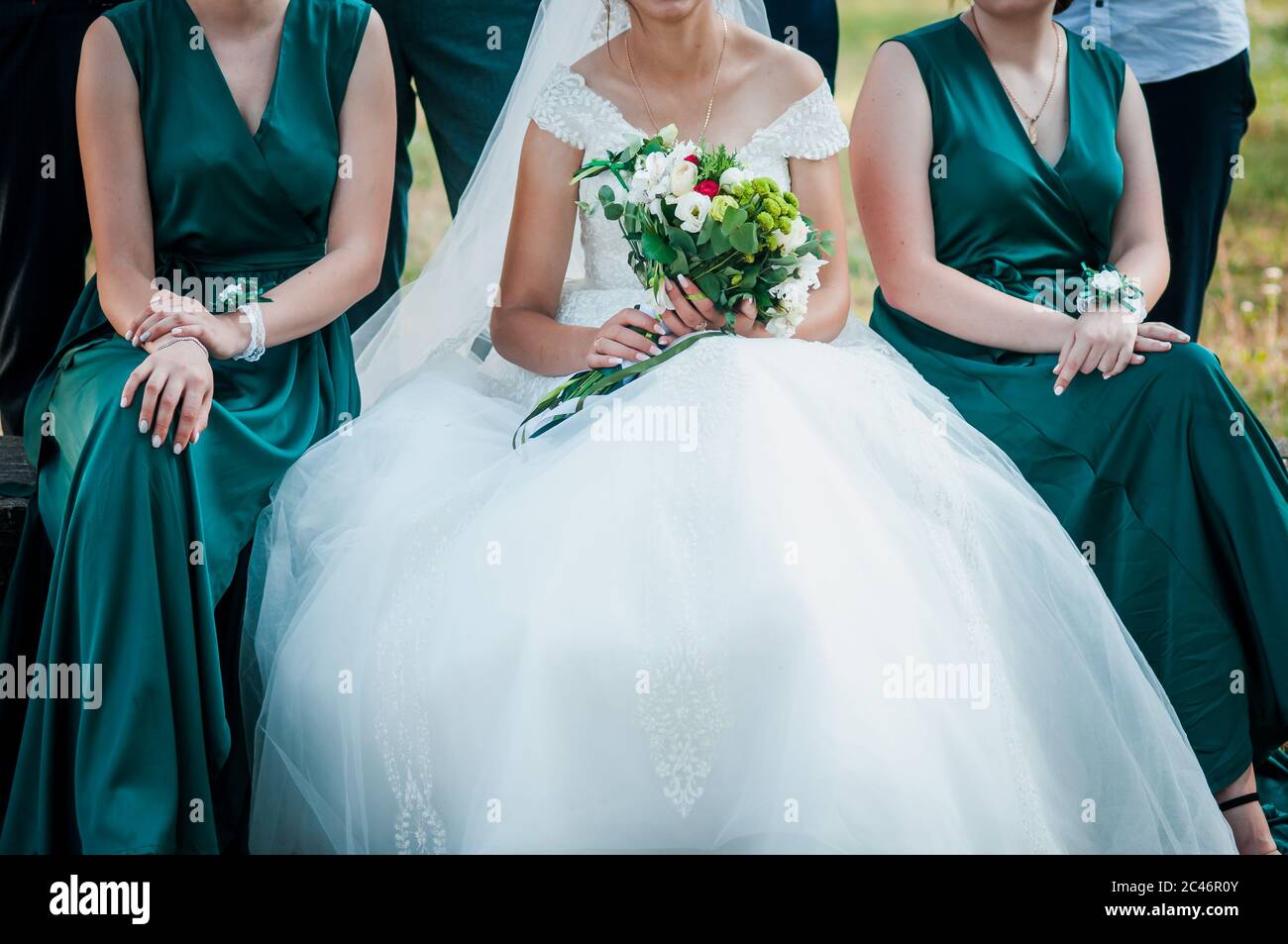 Bride and bridesmaid holding bouquet of flowers in the hand Stock Photo