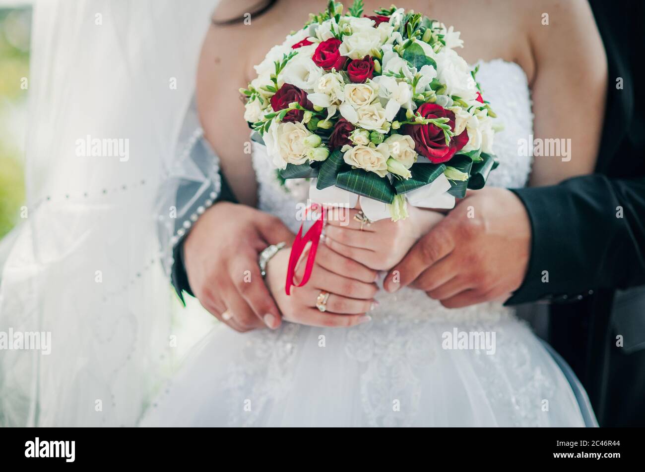 Colorfull wedding bouquet in the hands of bride Stock Photo