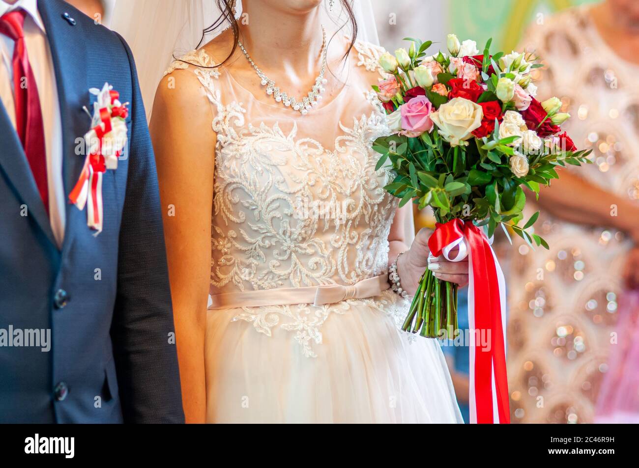 Bride holding colorfull flower bouquet in the hand Stock Photo