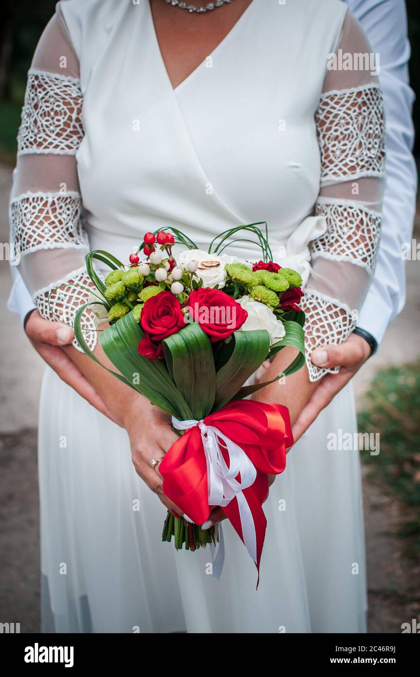 Colorfull flower bouquet of flowers in the hand of the bride Stock Photo
