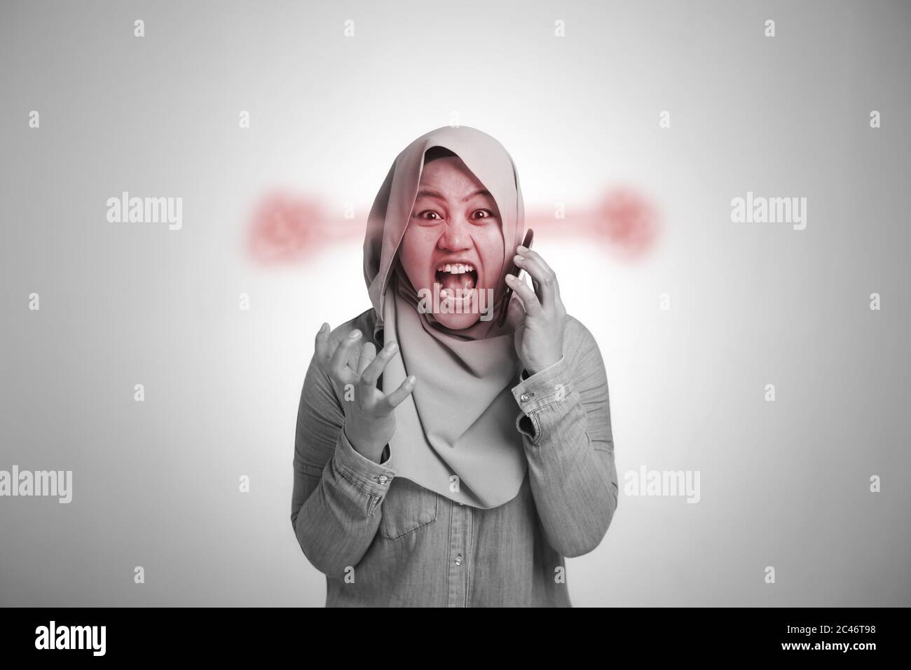Young Asian muslim woman angry by phone call, screaming on her phone ...