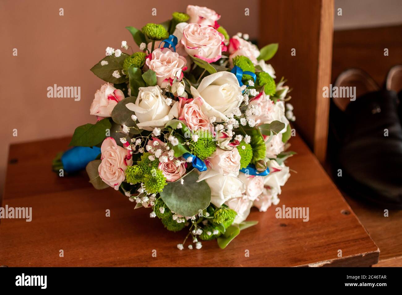 Bouquet of roses lying on the old table Stock Photo