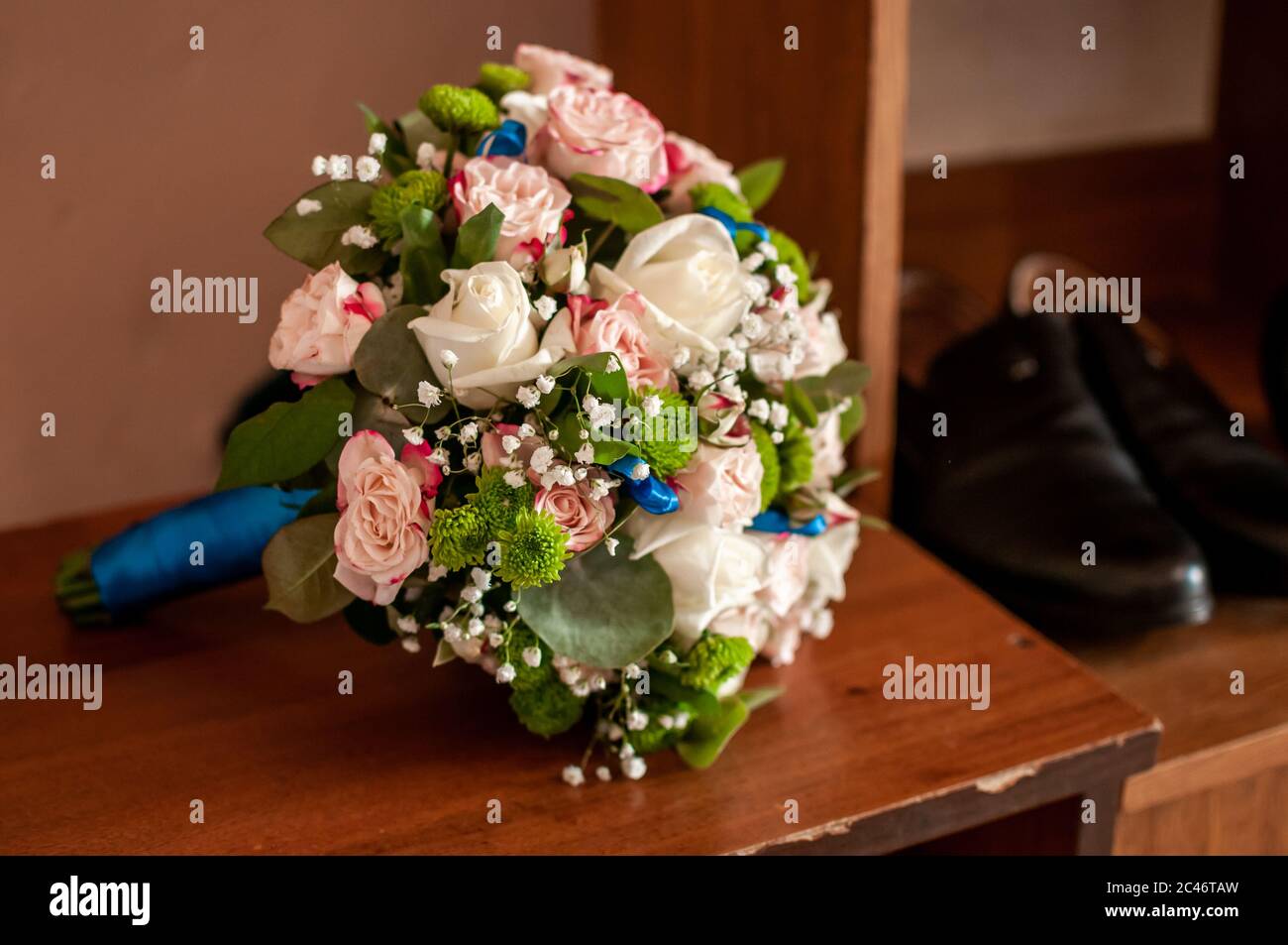 Bouquet of roses lying on the old table Stock Photo