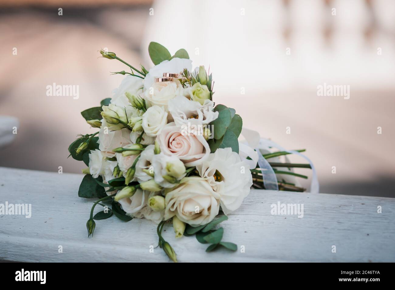 Pair Of Gold Wedding Rings On The White Flower Bouquet Stock Photo Alamy