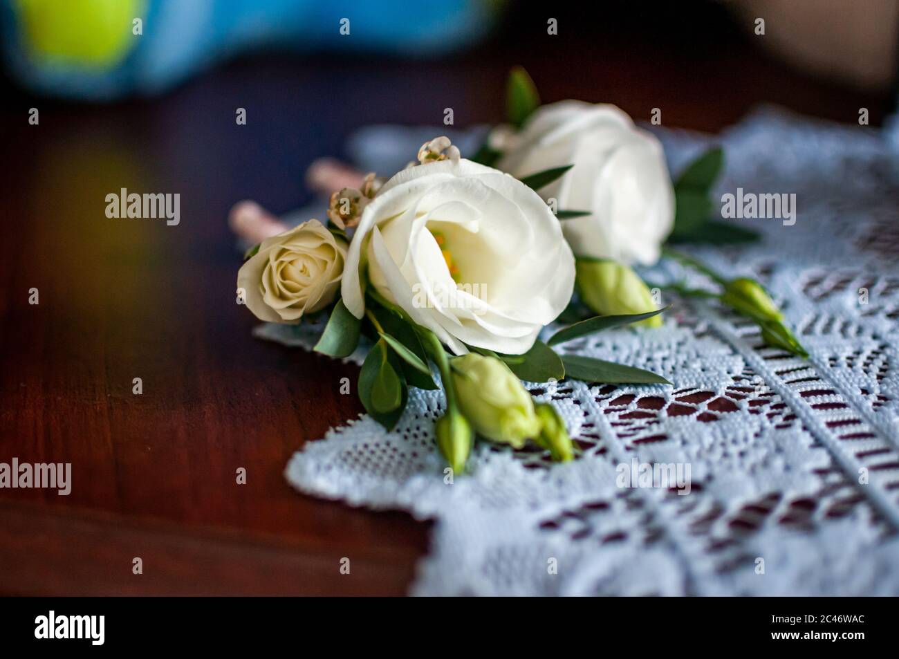 White rose with green leafs lying on the white table Stock Photo