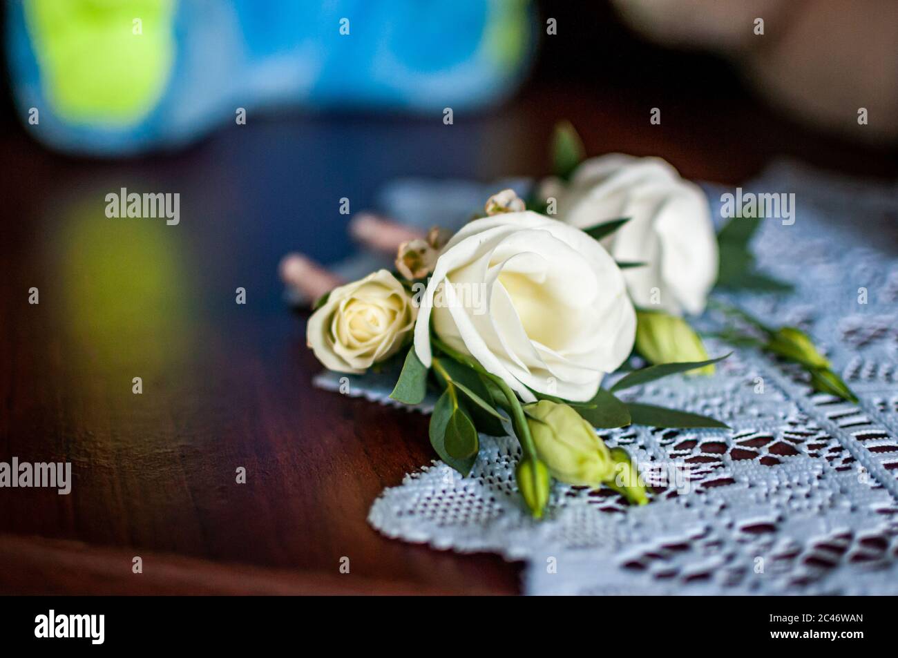 White rose with green leafs lying on the white table Stock Photo