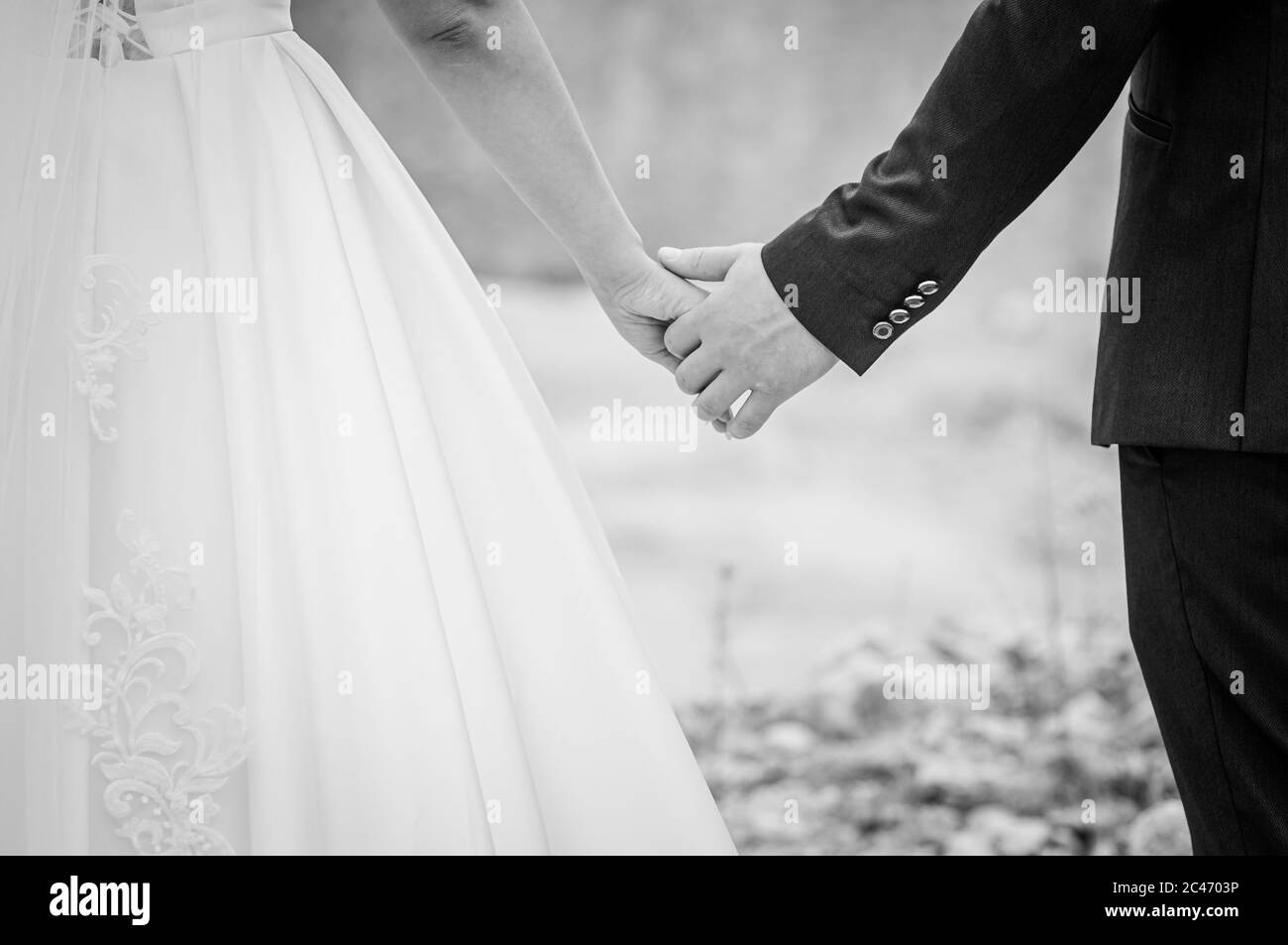 Couple of married holding hands black and white Stock Photo - Alamy